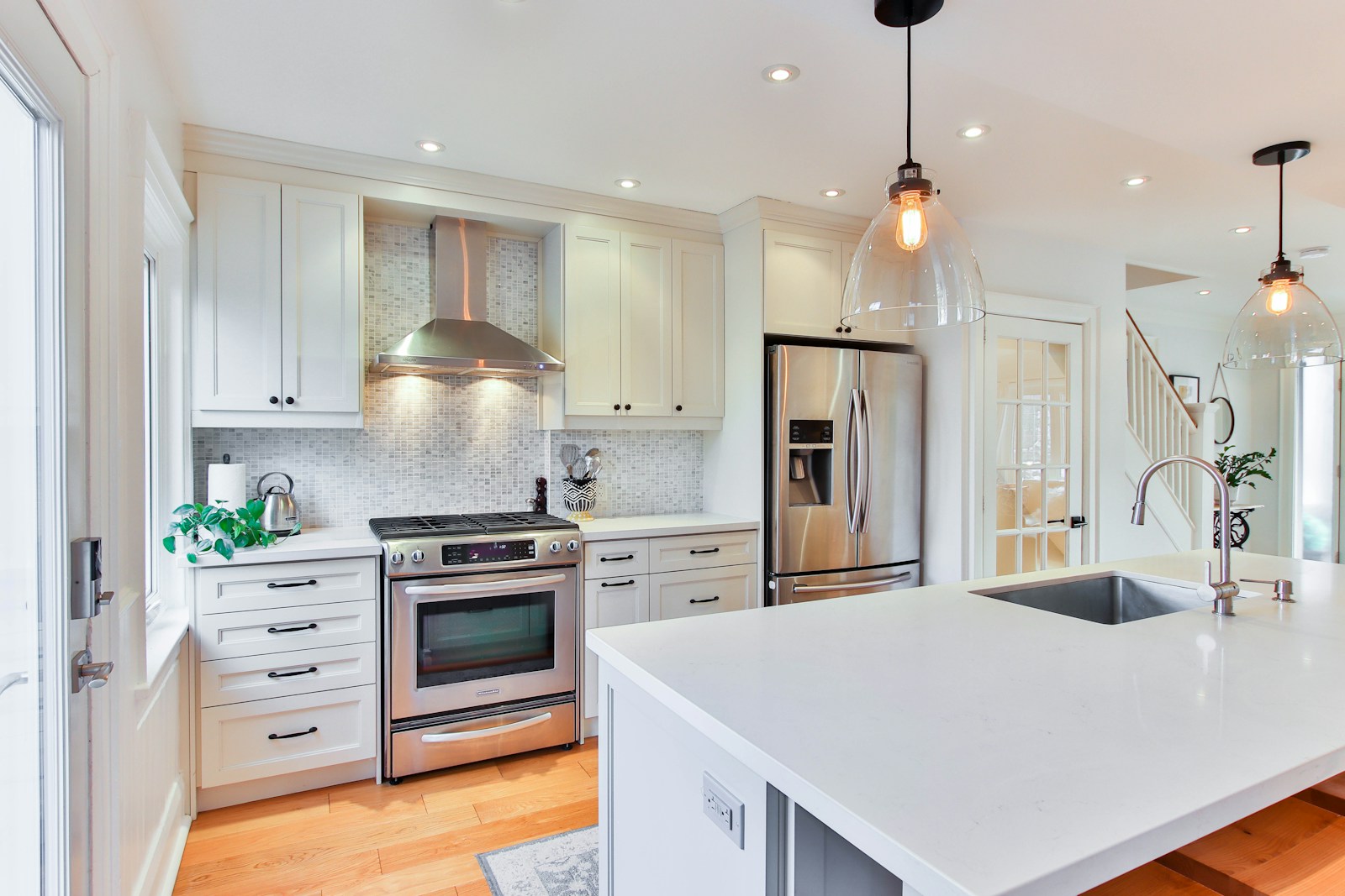 Photo by Lotus Design N Print white wooden kitchen cabinet and white kitchen counter
